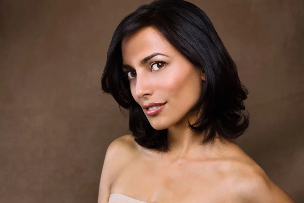 Skin care. Woman with beauty face touching healthy facial skin portrait. Beautiful smiling girl model | SpaGo MedSpa in Erie, PA.
